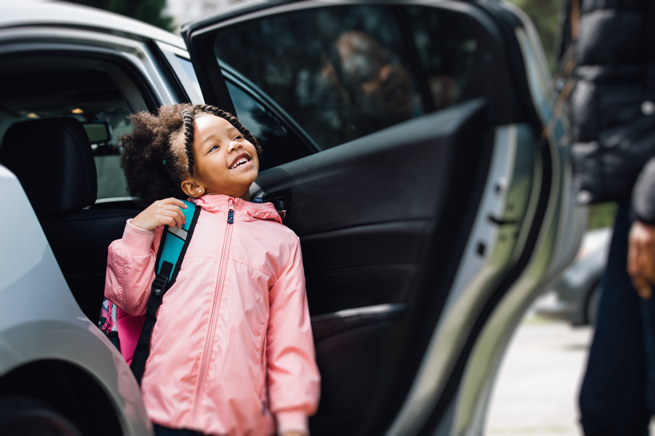 young girl going to school with parent